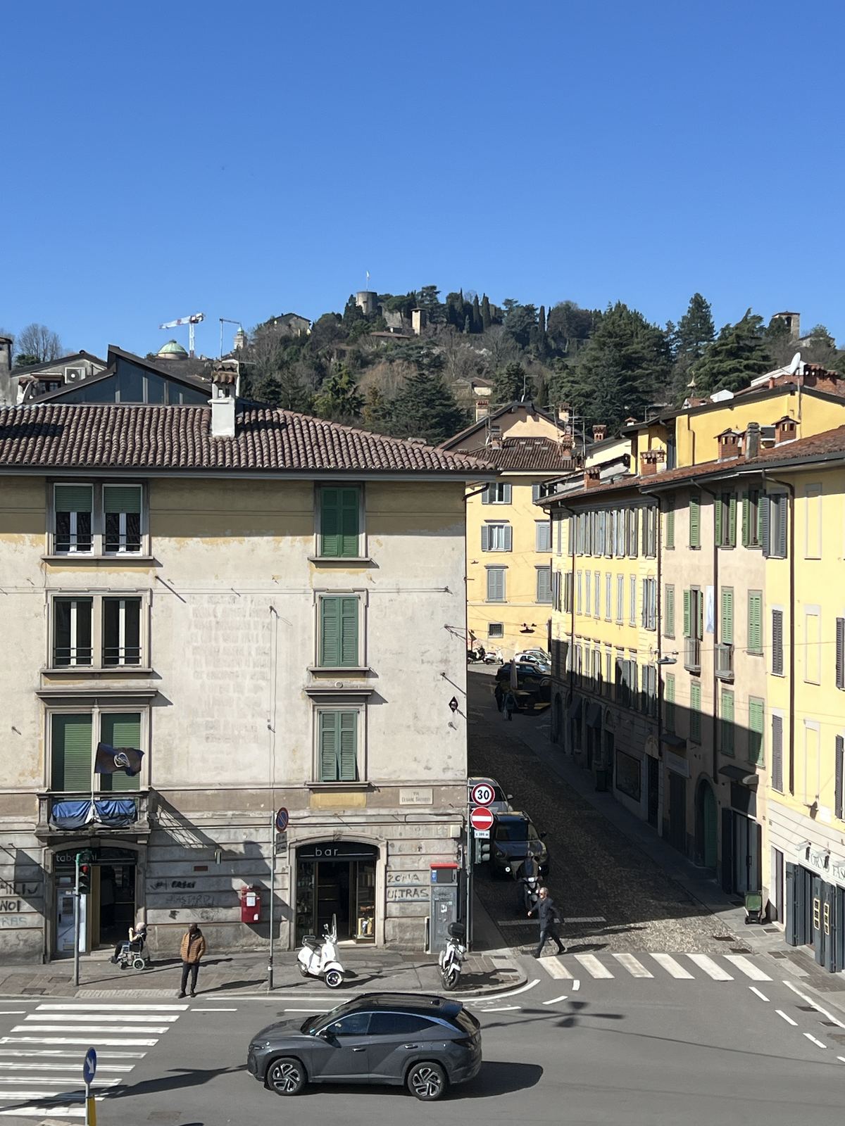 Yellow palazzi with Citta Alta on the hill behind